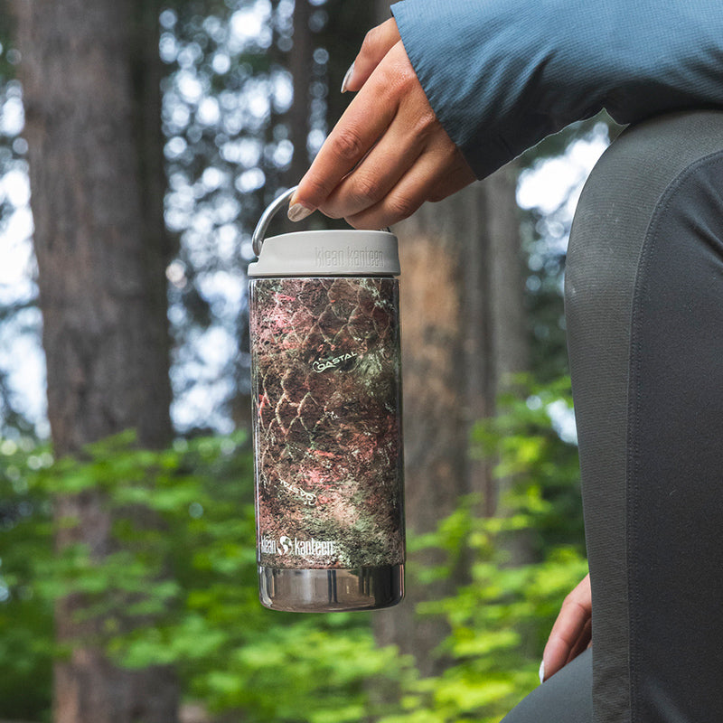 12oz-tkwide-with-twist-cap-mossy-oak-u0 12oz_tumbler_mossyoak_rainbowtrout_hand_closeup_square.jpg