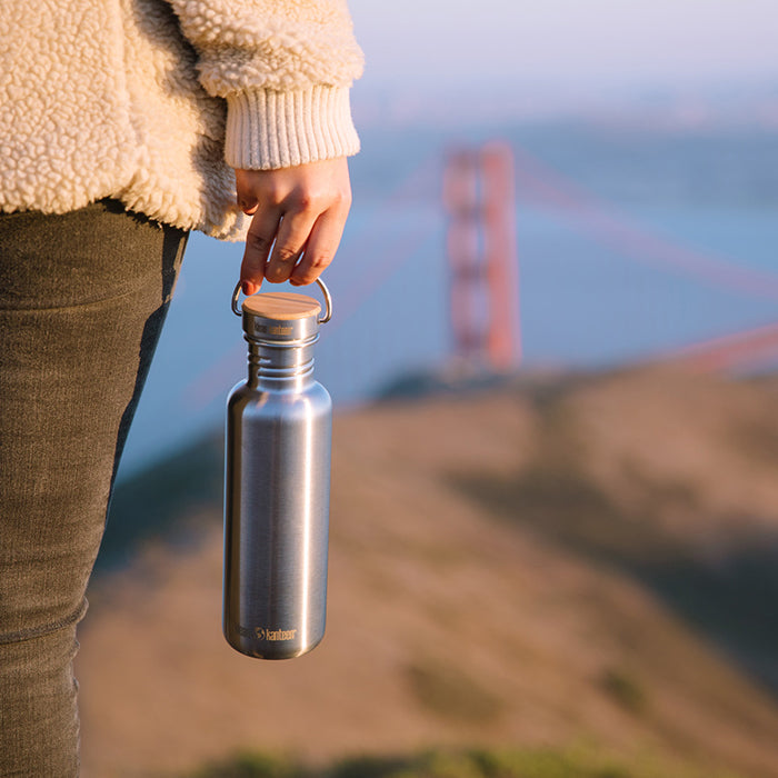 27oz-reflect-with-bamboo-cap-j7 K27SSLRF-BS-BAMBOO_reflect_bottle_bridge_lifestyle.jpg