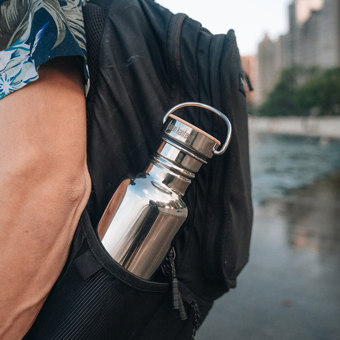 27oz-reflect-with-bamboo-cap-j7 K27SSLRF-MS-BAMBOO_reflect-bottle_backpack_lifestyle.jpg